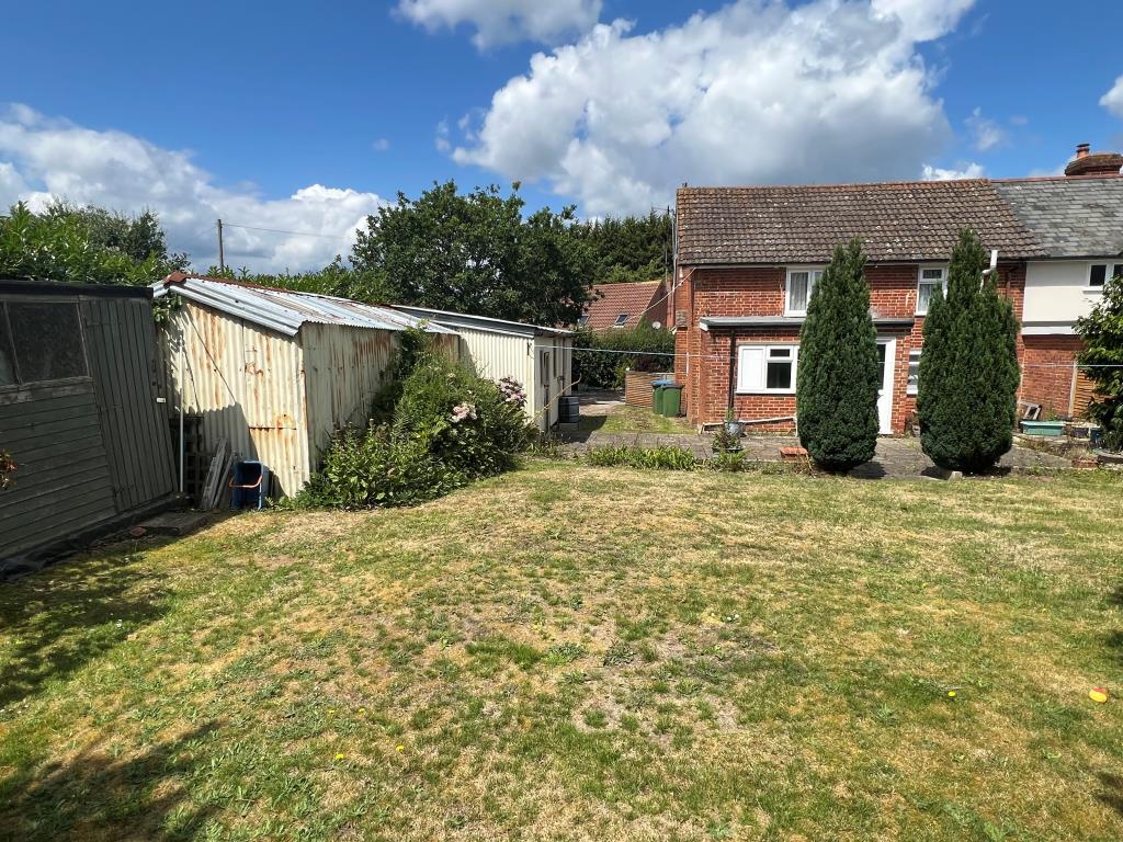 Lot: 128 - THREE-BEDROOM COTTAGE FOR IMPROVEMENT ON FIFTH OF AN ACRE PLOT WITH POTENTIAL - View of the rear of the property from the garden